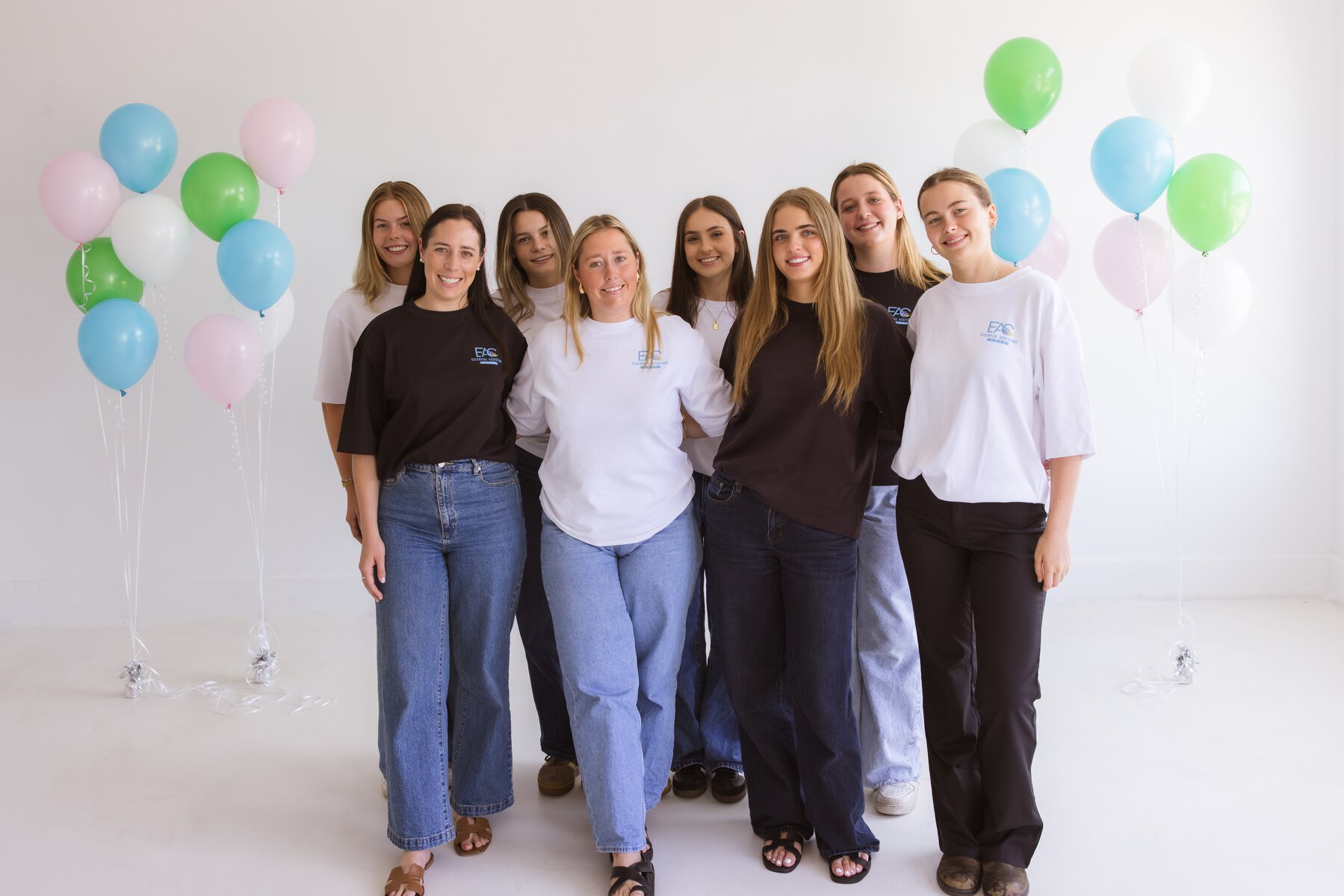 Essential Assistant Care team members together at a professional studio event