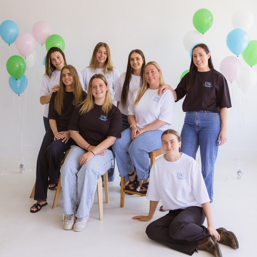 Essential Assistant Care team members gathered at a studio event