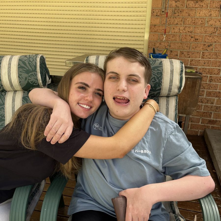 Client and support worker smiling together at home