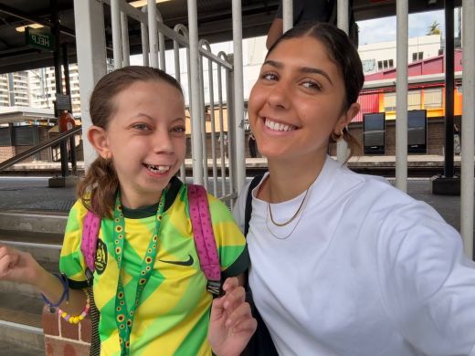 A client and support worker smiling together during a community outing