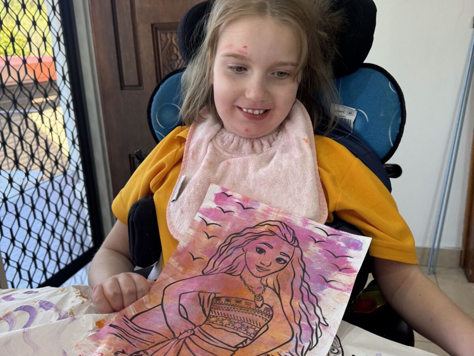 Participant smiling while completing an art activity