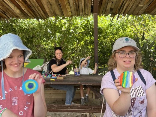 Clients taking part in a colourful outdoor art activity